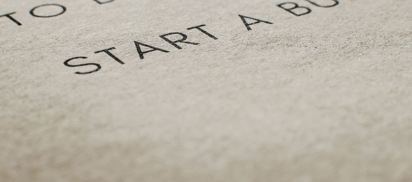 A notepad with the handwritten line: To do — start a business